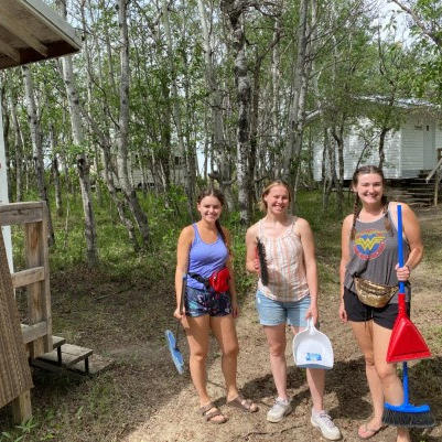 three people in clean up gear