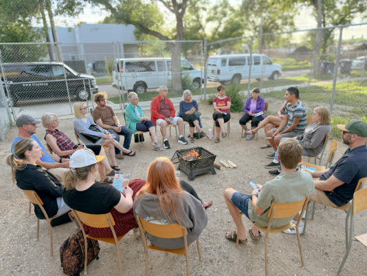 people sitting around a campfire