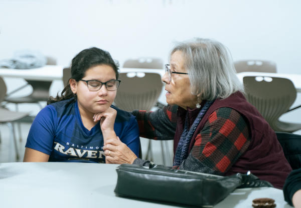 Sheila praying with a girl
